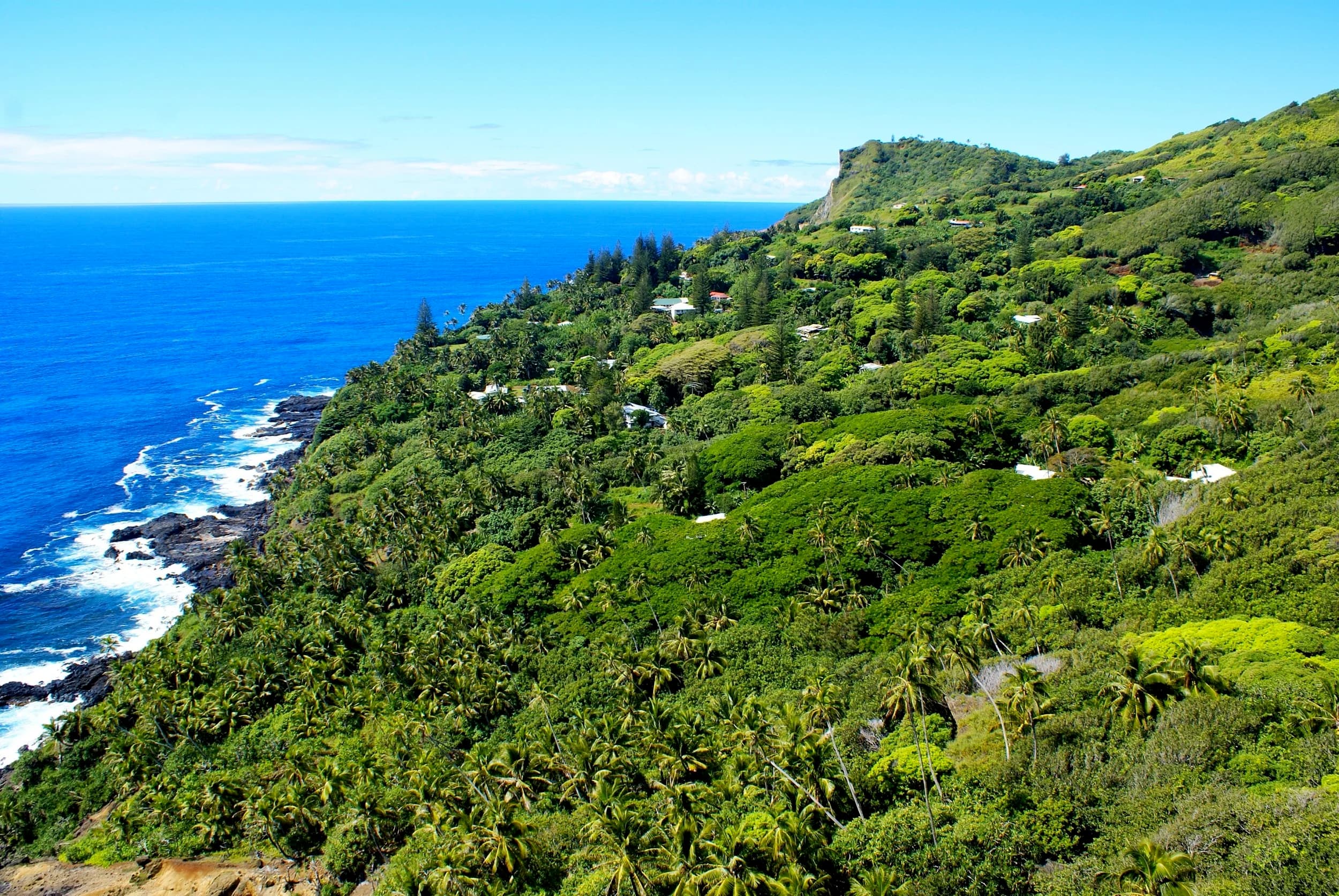 Pitcairn Island's green hillside running down to the sea at Adamstown