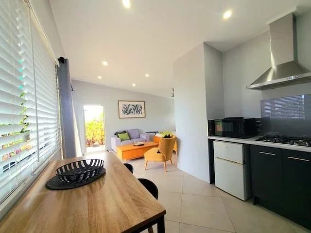 The kitchen and dining table, looking through to the lounge and deck